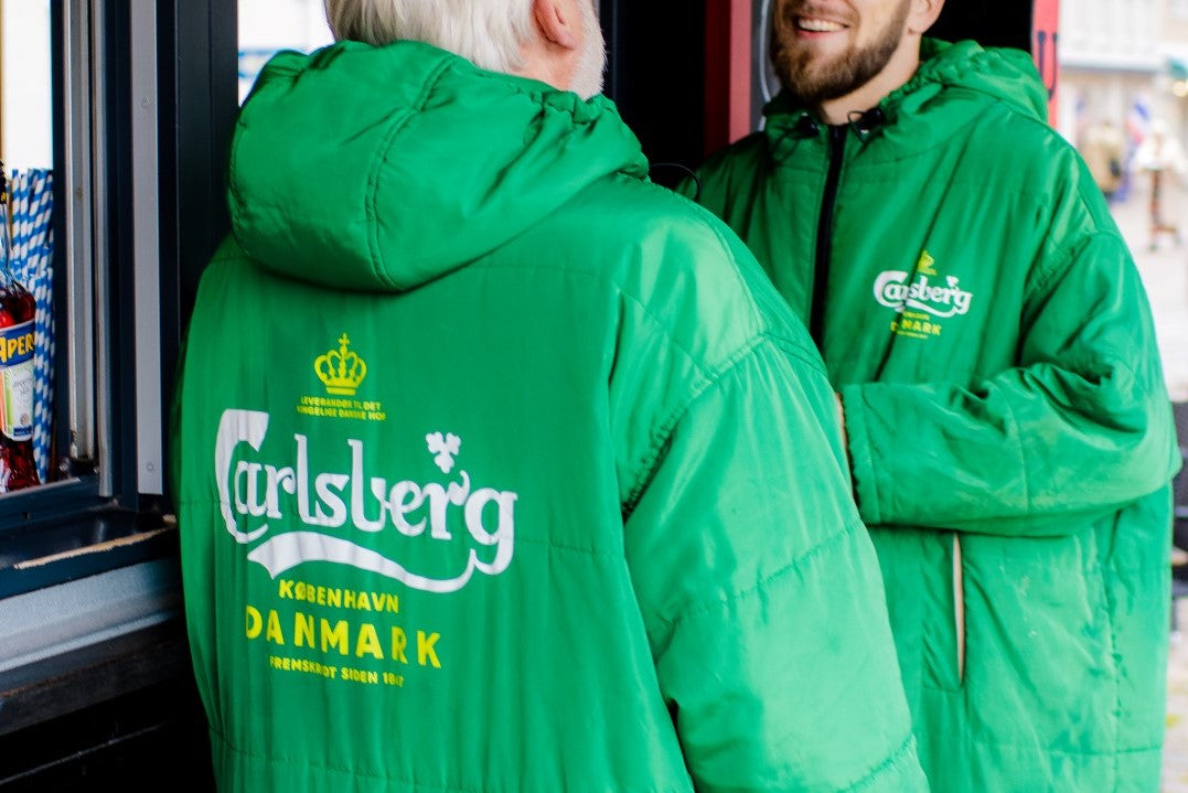 restaurant guests wearing carlsberg customized  sittingsuits in denmark